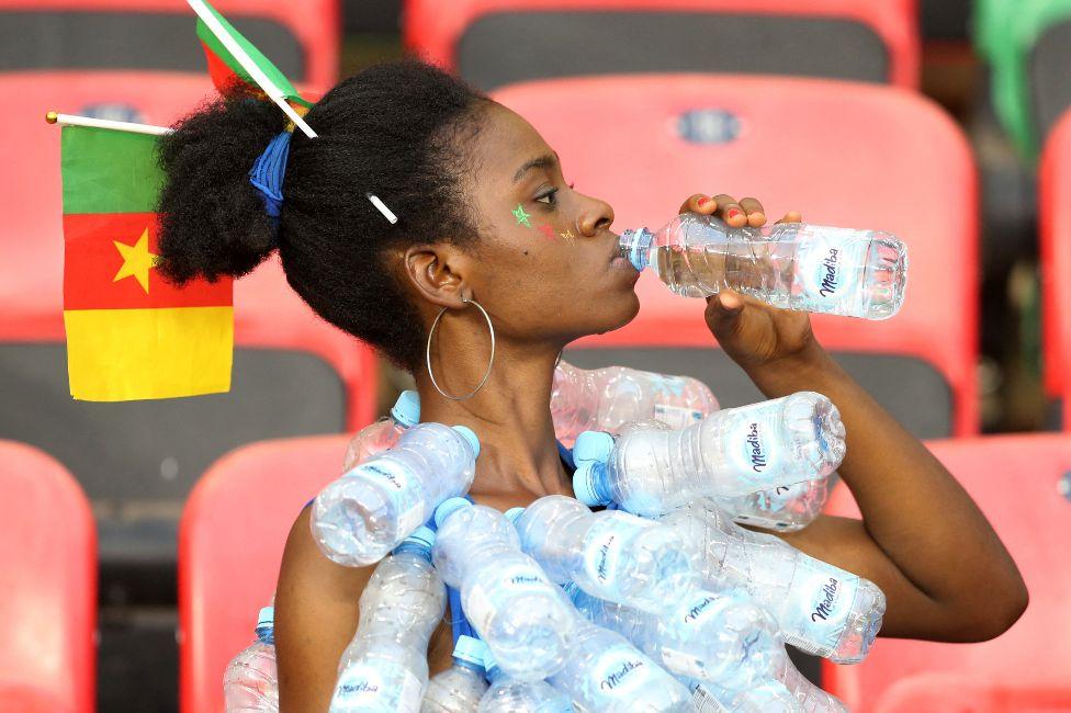 The country is currently hosting the Africa Cup of Nations - and a local football fan comes to a stadium in the capital, Yaoundé, on Monday prepared for the hot weather... The country is currently hosting the Africa Cup of Nations - and a local football fan comes to a stadium in the capital, Yaoundé, on Monday prepared for the hot weather...