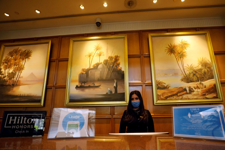 A receptionist is seen ready for work at Conrad, one of hotels in Egypt that received a stamp of approval to reopen amid the COVID-19 crisis, as Egypt ramps up efforts to slow the spread of the coronavirus disease (COVID-19), in Cairo