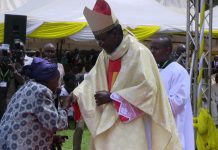Catholic faithful sing and praise as bishop installed
