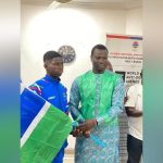 Minister Badjie Hands over National Flag to Team Gambia Minister Badjie Hands over National Flag to Team Gambia