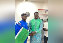 Minister Badjie Hands over National Flag to Team Gambia Minister Badjie Hands over National Flag to Team Gambia
