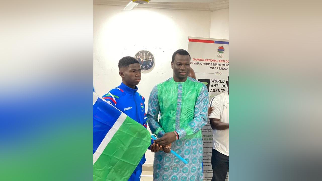 Minister Badjie Hands over National Flag to Team Gambia Minister Badjie Hands over National Flag to Team Gambia