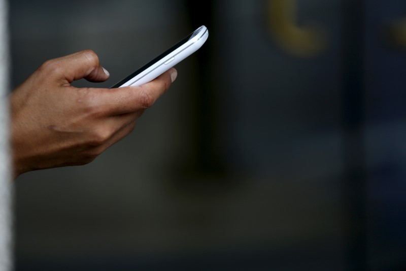 A woman uses a mobile device while working out in San Francisco