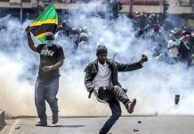 Mob Attacks Police Officer Amid Tanzania Poll Chaos Mob Attacks Police Officer Amid Tanzania Poll Chaos