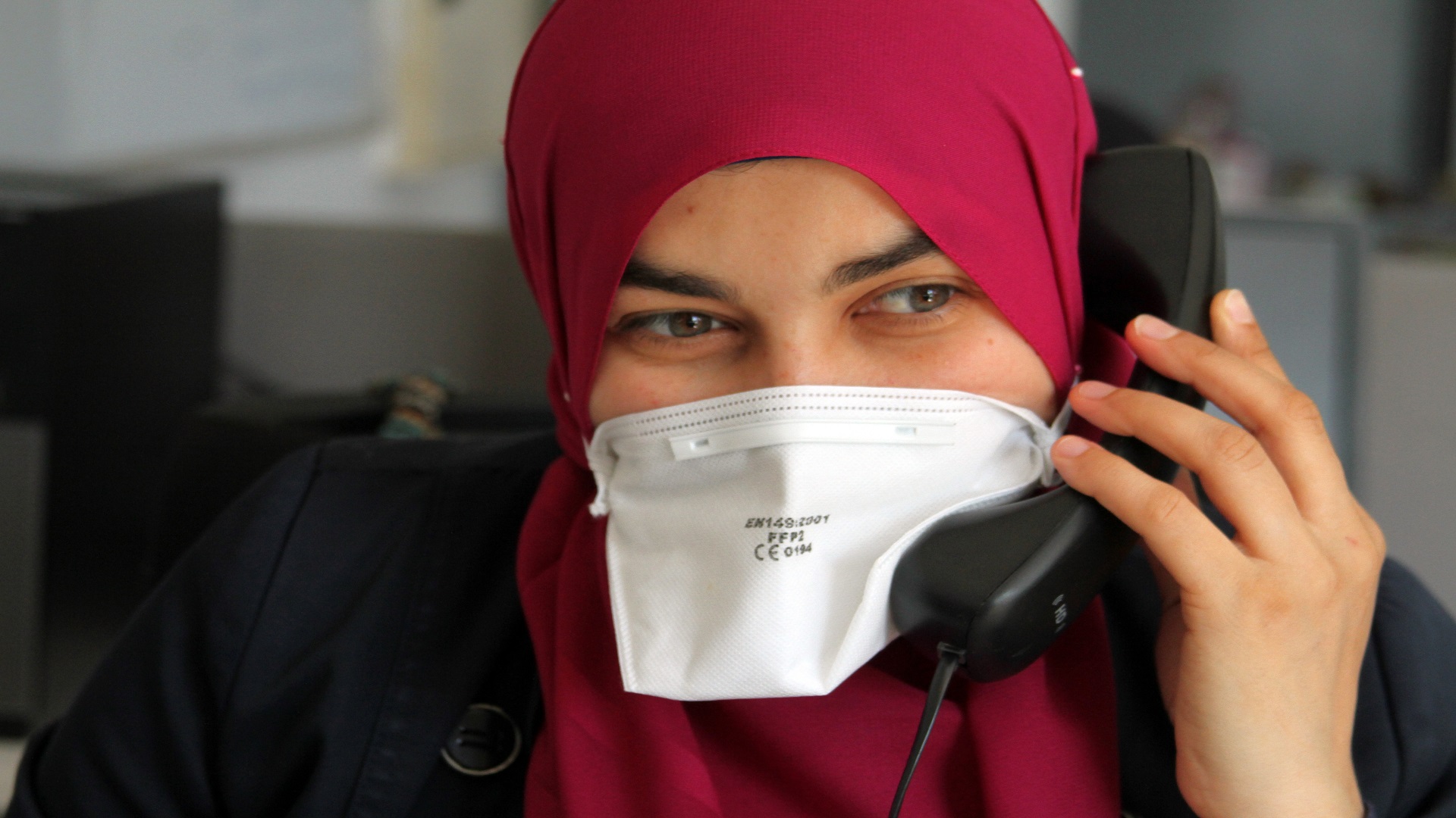 A medical assistant attending to COVID-19 disease-related