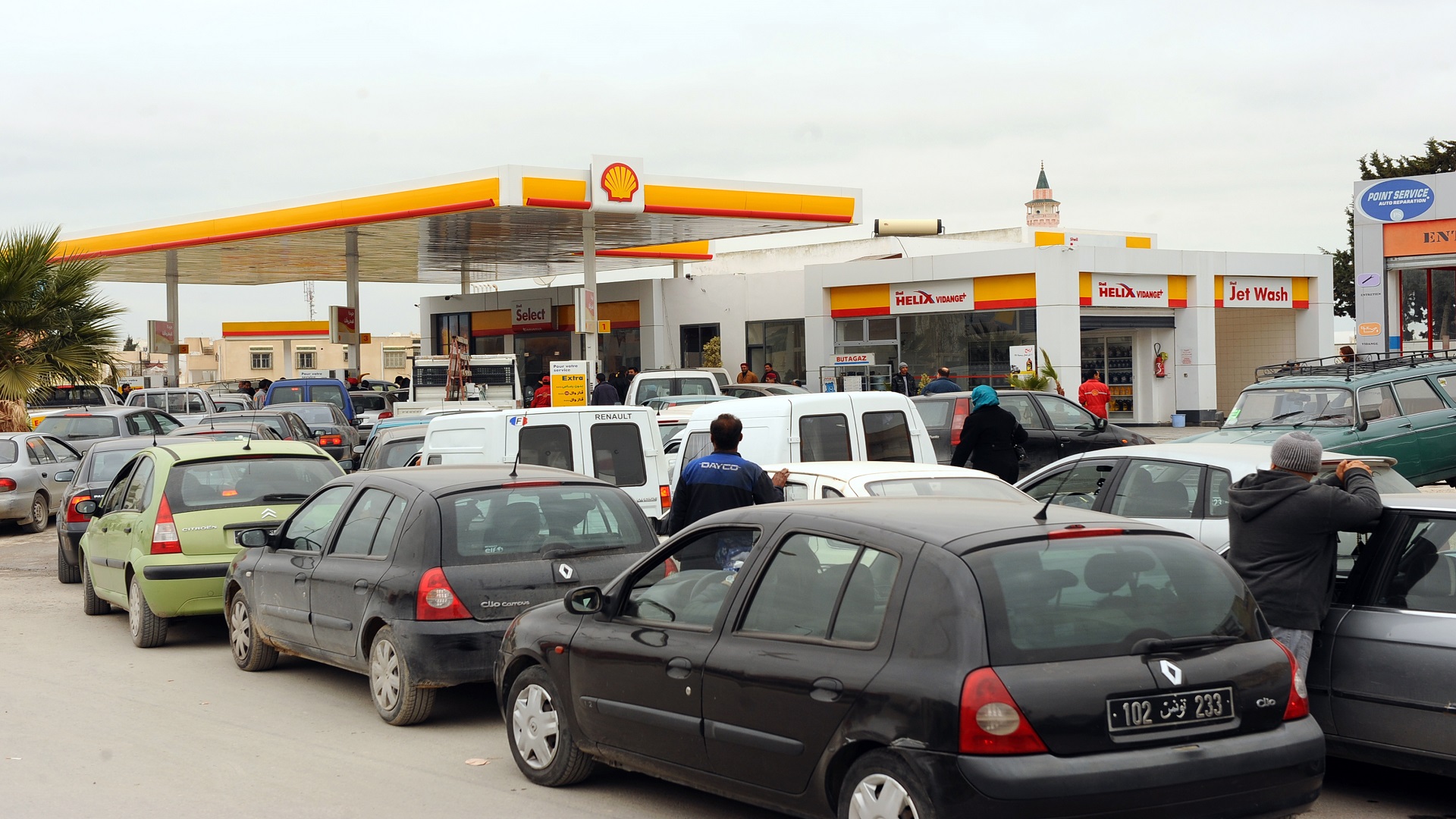Cars wait in line at a Shell gas station