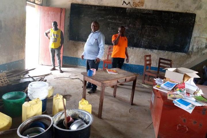 Refugees split school desks for firewood Refugees split school desks for firewood