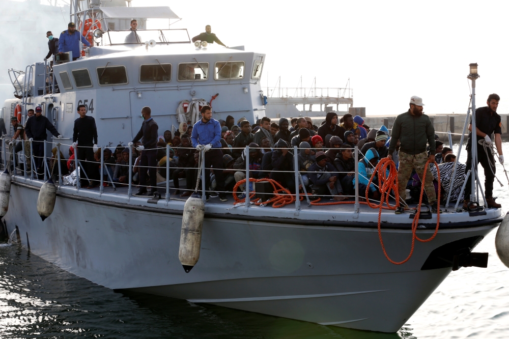 A Libyan Navy boat with migrants on board arrives at navy base in Tripoli